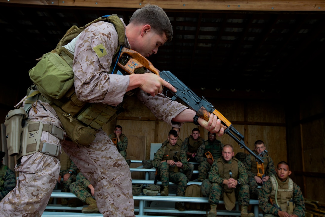 A force reconnaissance Marine demonstrates firing positions for a role-player class during Special Purpose Marine Air Ground Task Force 2012’s mission rehearsal exercise Sept. 20. SPMAGTF-12 is slated to deploy in support of U.S. Africa Command. ::r::::n::::r::::n::::r::::n::