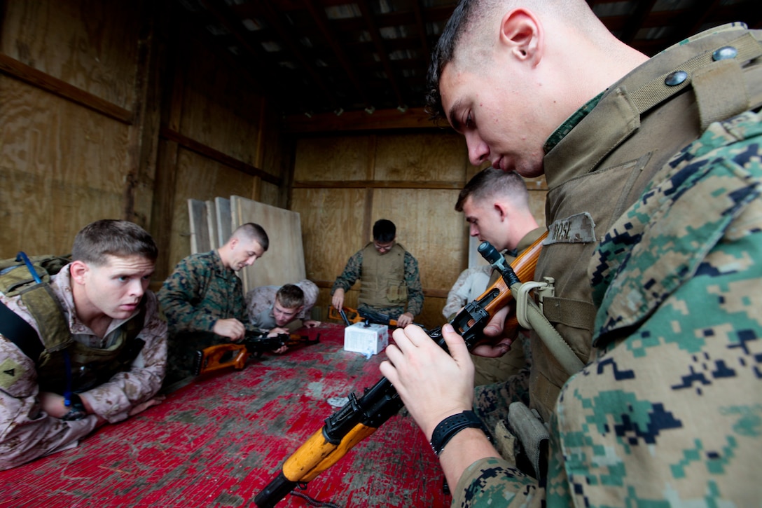 Force reconnaissance Marines watch as role players practice assembling AK-M rifles during Special Purpose Marine Air Ground Task Force 2012’s mission rehearsal exercise Sept. 20. SPMAGTF-12 is slated to deploy in support of U.S. Africa Command. ::r::::n::