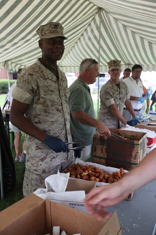 Col. Grover C. Lewis III, the assistant chief of staff and director of Security and Emergency Services aboard Marine Corps Base Camp Lejeune serves hushpuppies at a fish fry held by the Jacksonville-Onslow Chamber of Commerce Military Affairs Committee.  (Official U.S. Marine Corps photo by Pfc. Jackeline M. Perez Rivera)
