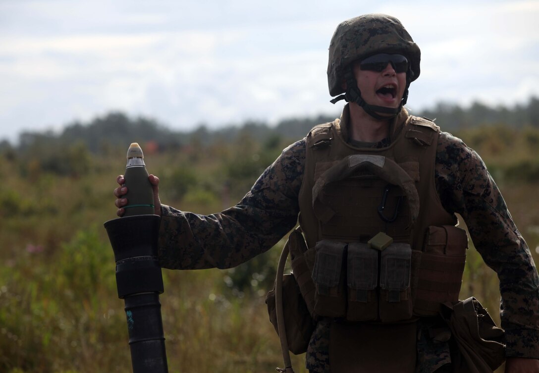 Lance Cpl. Kevin Thompson, squad leader, 3rd Battalion, 8th Marine Regiment, 2nd Marine Division, prepares to drop an 81 millimeter mortar round into the mortar tube aboard Marine Corps Base Camp Lejeune, N.C., September 21. He and his fellow Marines were participating in the Infantry Mortar Leaders Course.