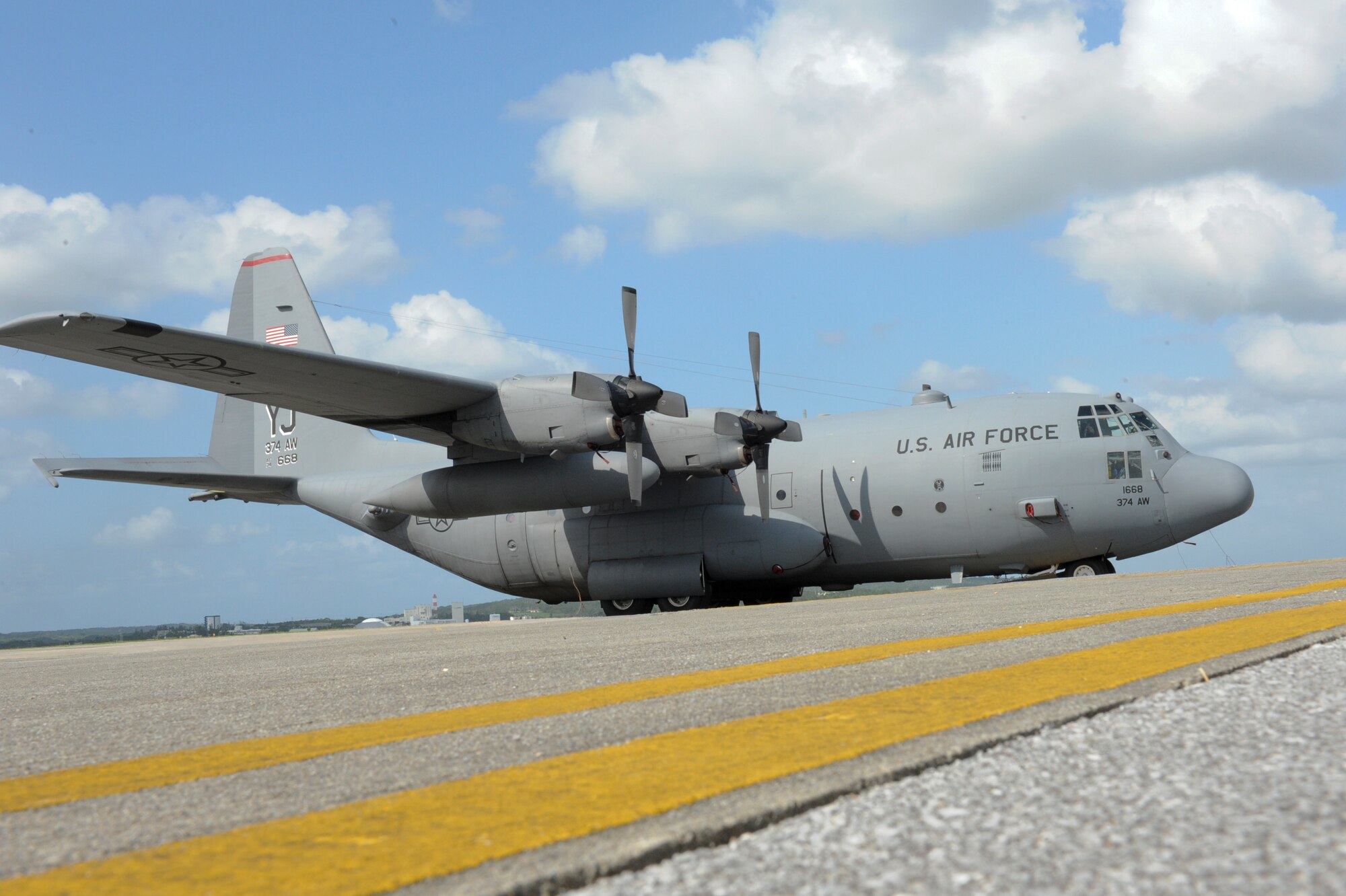 A U.S. Air Force C-130 Hercules cargo plane is parked on the flightline on Kadena Air Base, Japan,  after being evacuated from Yokota Air Base, Japan, due to approaching Typhoon Roke Sept. 21. Airmen from Kadena's 18th Operations Group, 18th Logistics Readiness Squadron and 733rd Air Mobility Squadron helped bed-down and receive the aircraft and crews from Yokota during their brief stay here.  (U.S. Air Force photo/Airman 1st Brooke P. Beers)