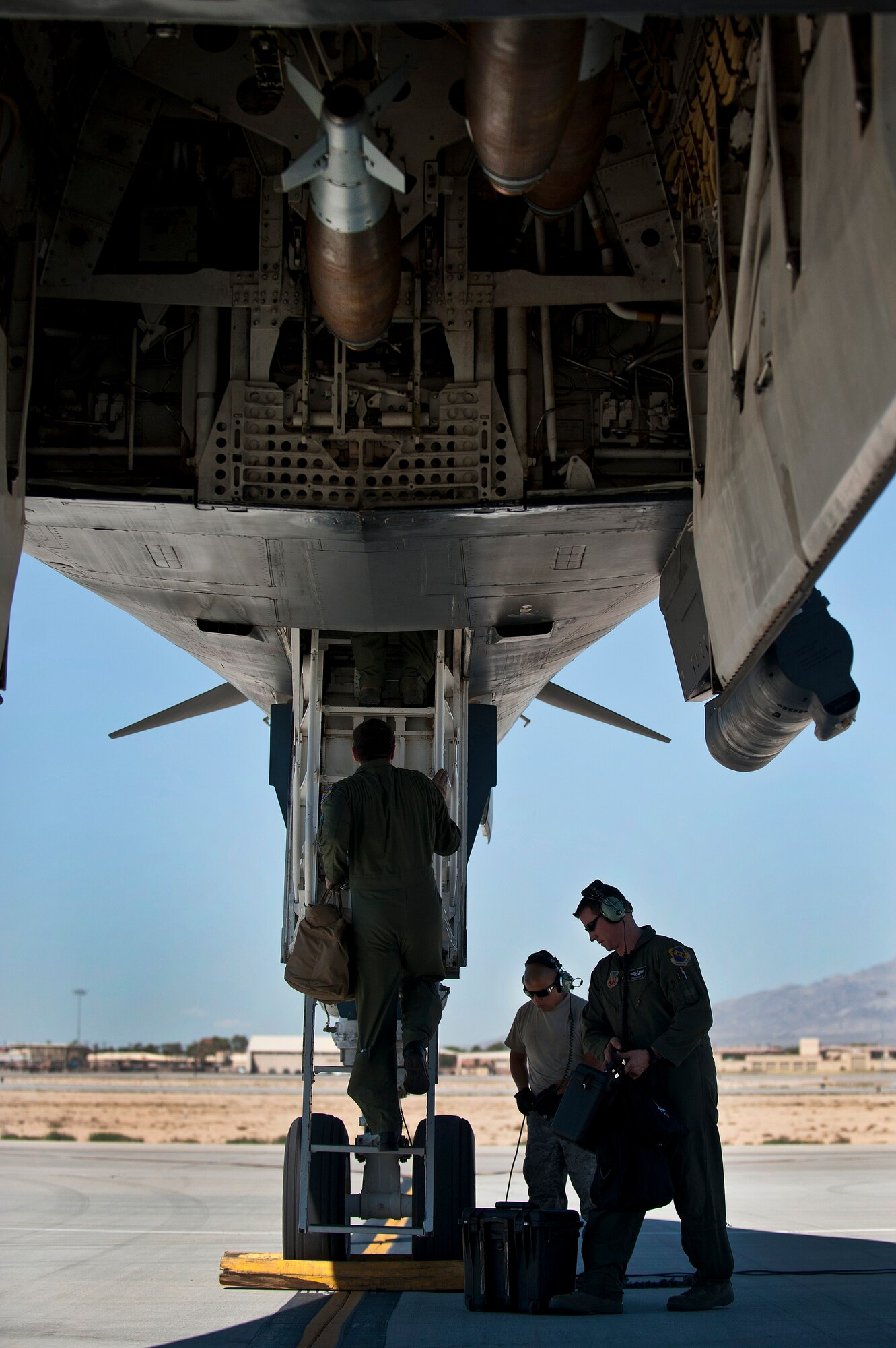 U.S. Air Force pilots from the 9th Bomb Squadron, Dyess Air Force Base, Texas, climb into the cockpit of a B-1B Lancer to perform pre-flight checks for a training mission during Green Flag-West 11-10 Sept. 20, 2011, at Nellis AFB, Nev. Green Flag-West provides a realistic close-air support training environment for forces preparing to support worldwide combat operations.(U.S. Air Force photo by Airman 1st Class George Goslin/Released)
