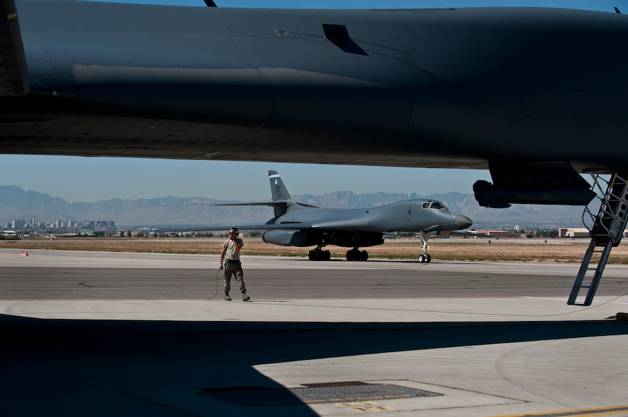 U.S. Air Force Airman 1st Class Bradley Skelton, 7th Aircraft Maintenance Squadron crew chief, Dyess Air Force Base, Texas, performs pre-flight checks before a training mission during Green Flag-West 11-10 Sept. 20, 2011, at Nellis AFB, Nev. Green Flag-West provides a realistic close-air support training environment for forces preparing to support worldwide combat operations.(U.S. Air Force photo by Airman 1st Class George Goslin/Released)
