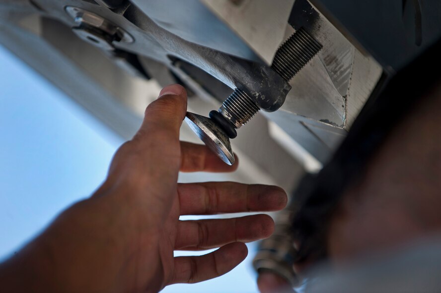 U.S. Air Force Senior Airman Kai Graves, 7th Aircraft Maintenance Squadron communication navigation journeyman, Dyess Air Force Base, Texas, screws in a bolt for a sniper targeting pod to be mounted on a B-1B Lancer before a training mission during Green Flag-West 11-10 Sept. 20, 2011, at Nellis AFB, Nev. Green Flag-West provides a realistic close-air support training environment for forces preparing to support worldwide combat operations. (U.S. Air Force photo by Airman 1st Class George Goslin/Released)
