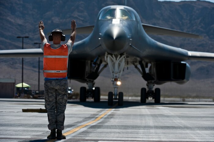 U.S. Air Force Senior Airman Jonathon Hartman, 7th Aircraft Maintenance Squadron crew chief, Dyess Air Force Base, Texas, marshals in a B-1B Lancer during Green Flag-West 11-10 Sept. 20, 2011, at Nellis AFB, Nev. Green Flag-West provides a realistic close-air support training environment for forces preparing to support worldwide combat operations.(U.S. Air Force photo by Senior Airman Brett Clashman/Released)