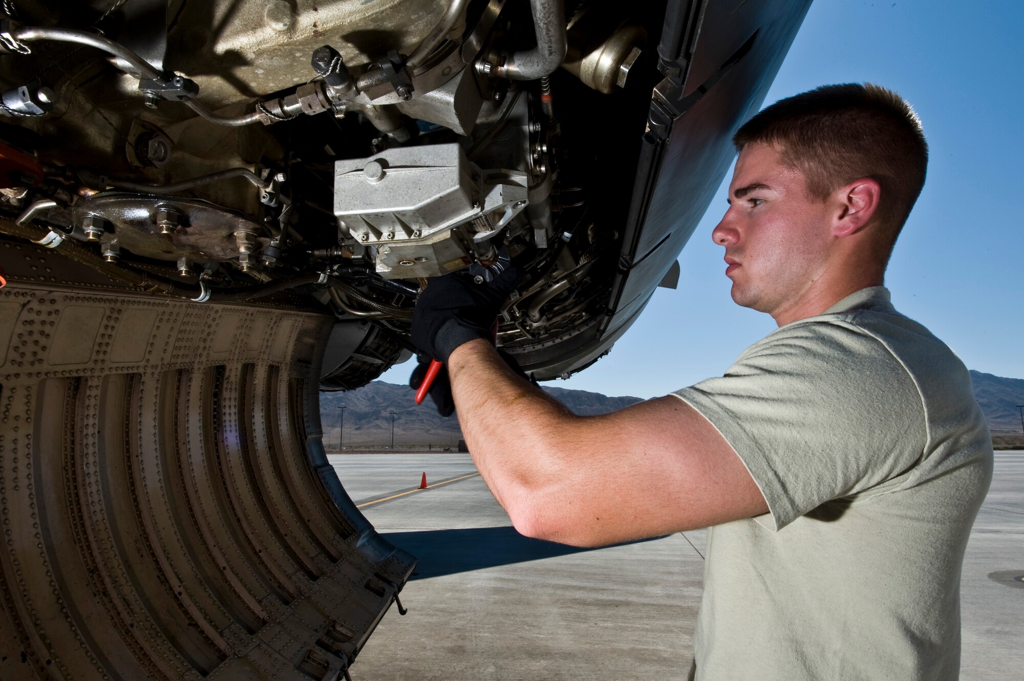 U.S. Air Force Staff Sgt. Justin Sparks, 7th Aircraft Maintenance Squadron engine mechanics, inspect underneath a B1-B Lancer engine during Green Flag-West 11-10 Sept. 20, 2011, at Nellis AFB, Nev. Green Flag-West provides a realistic close-air support training environment for forces preparing to support worldwide combat operations.(U.S. Air Force photo by Senior Airman Brett Clashman/Released)
