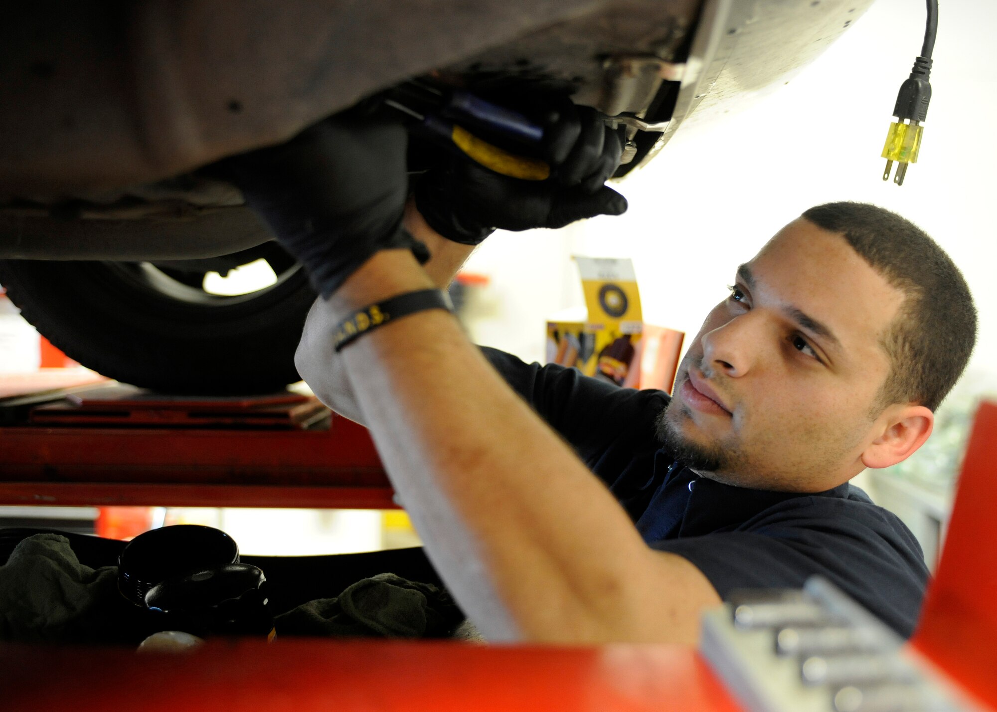 Jose Vazquez tightens the oil filter on a vehicle as part of a winter inspection here Tuesday, at Eielson Air Force Base, Alaska. Winter inspections and the winterization of your vehicle are a crucial part of staying mission ready during the winter months in Alaska. Mr. Vazquez is an automotive mechanic at the Auto Care Center at the Base Exchange. (U.S. Air Force Photo/Senior Airman Willard E. Grande II)