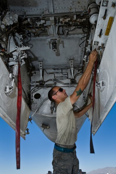 U.S. Air Force Airman 1st Class Bradley Skelton, 7th Aircraft Maintenance Squadron crew chief, Dyess Air Force Base, Texas, pulls the safety pins during a pre-flight inspection on a B-1B Lancer during Green Flag-West 11-10 Sept. 20, 2011, at Nellis AFB. Nev. Green Flag-West provides a realistic close-air support training environment for forces preparing to support worldwide combat operations. (U.S. Air Force photo by Airman 1st Class Daniel Hughes/Released)