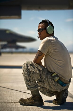 U.S. Air Force Airman 1st Class Oscar Masga, 7th Aircraft Maintenance Squadron crew chief,  Dyess Air Force Base, Texas, listens via headset to pilots while conducting pre-flight checks during Green Flag-West 11-10  Sept. 15, 2011, at Nellis AFB. Nev. Green Flag-West provides a realistic close-air support training environment for forces preparing to support worldwide combat operations. (U.S. Air Force photo by Airman 1st Class Daniel Hughes/Released)