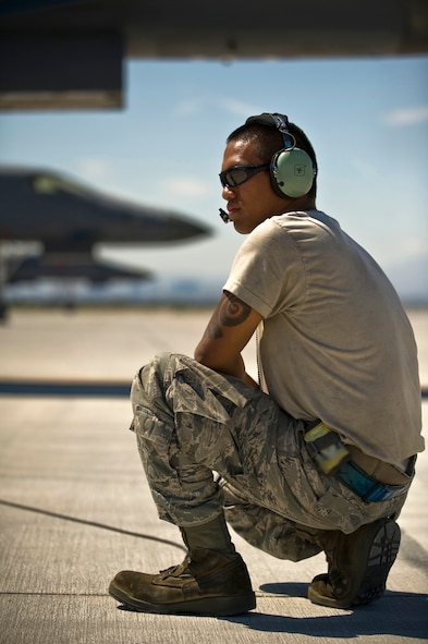 U.S. Air Force Airman 1st Class Oscar Masga, 7th Aircraft Maintenance Squadron crew chief,  Dyess Air Force Base, Texas, listens via headset to pilots while conducting pre-flight checks during Green Flag-West 11-10  Sept. 15, 2011, at Nellis AFB. Nev. Green Flag-West provides a realistic close-air support training environment for forces preparing to support worldwide combat operations. (U.S. Air Force photo by Airman 1st Class Daniel Hughes/Released)