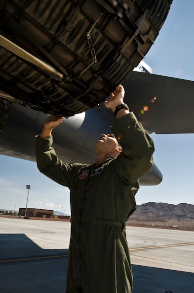 U.S. Air Force Capt. Jeremy Stover, 9th Bomb Squadron weapons systems operator, Dyess Air Force Base, Texas, inspects a B-1B Lancer before take off during Green Flag-West 11-10  Sept. 15, 2011, at Nellis AFB. Nev. Green Flag-West provides a realistic close-air support training environment for forces preparing to support worldwide combat operations.  (U.S. Air Force photo by Airman 1st Class Daniel Hughes/Released)