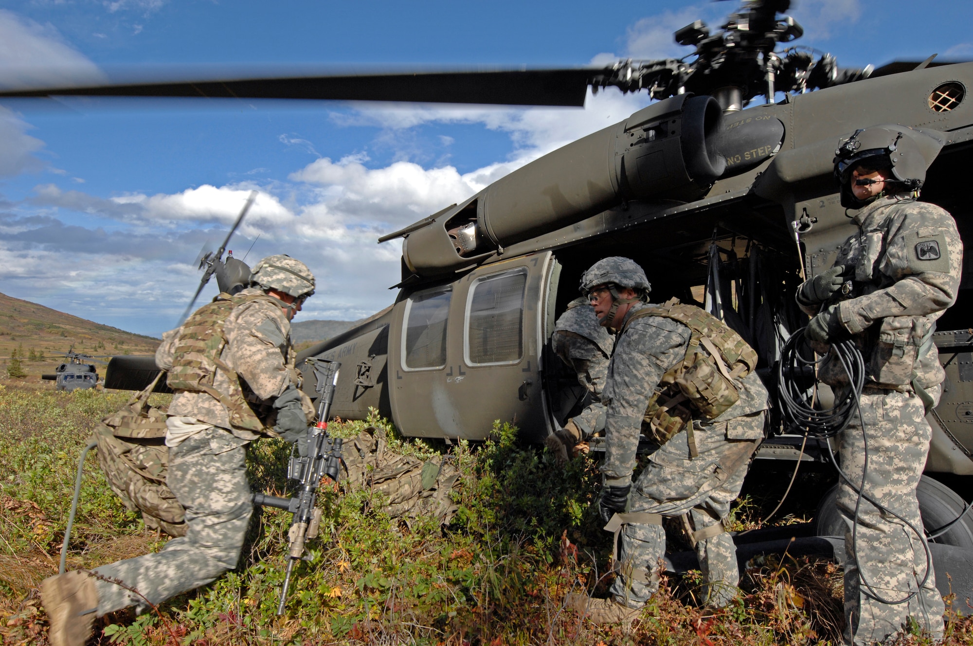 Soldiers from 1st Squadron (Airborne), 40th Cavalry Regiment load a UH-60 Blackhawk helicopter during a training mission near Joint Base Elmendorf-Richardson, Sept. 13. The mission consisted of an air assault, security operations and setting up observation posts. The Soldiers are training in preparation for a deployment to Afghanistan later this year. (U.S. Air Force photo/Staff Sgt. Brian Ferguson)(Released) 