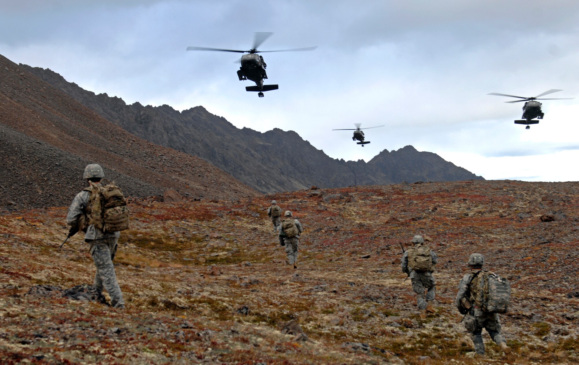 UH-60 Blackhawk helicopters fly over after dropping off Soldiers from 1st Squadron (Airborne), 40th Cavalry Regiment during a training mission near Joint Base Elmendorf-Richardson, Sept. 13. The mission consisted of an air assault, security operations and setting up observation posts. The Soldiers are training in preparation for a deployment to Afghanistan later this year. (U.S. Air Force photo/Staff Sgt. Brian Ferguson)(Released) 