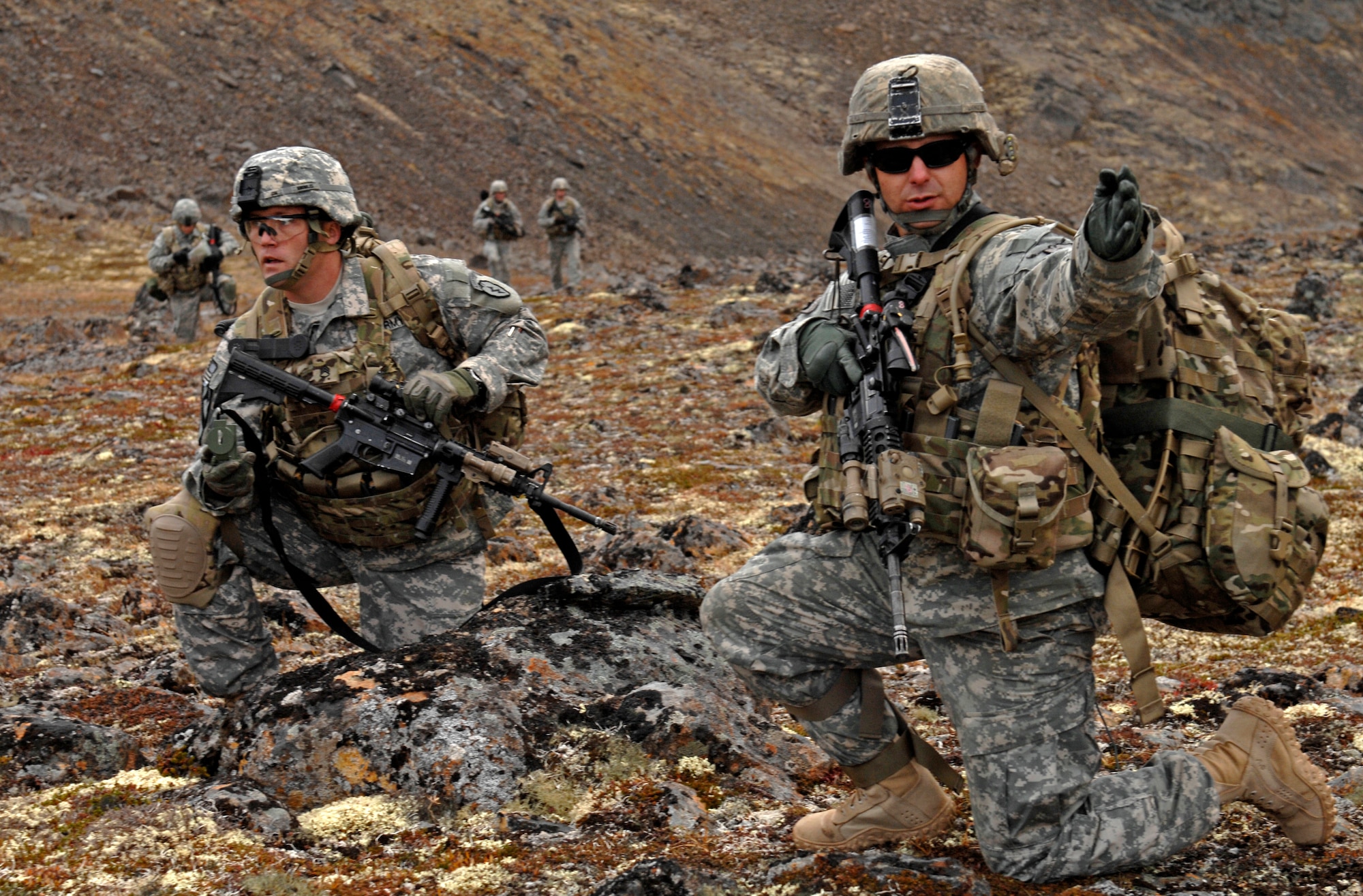 Army Staff Sgt. Brian Knowles, left, and Spc. Brian Livingston discuss the direction of travel after being dropped off by a UH-60 Blackhawk helicopter during a training mission near Joint Base Elmendorf-Richardson, Sept. 13. The mission consisted of an air assault, security operations and setting up observation posts. The Soldiers are training in preparation for a deployment to Afghanistan later this year. Knowles and Livingston are part of 1st Squadron (Airborne), 40th Cavalry Regiment. (U.S. Air Force photo/Staff Sgt. Brian Ferguson)(Released) 