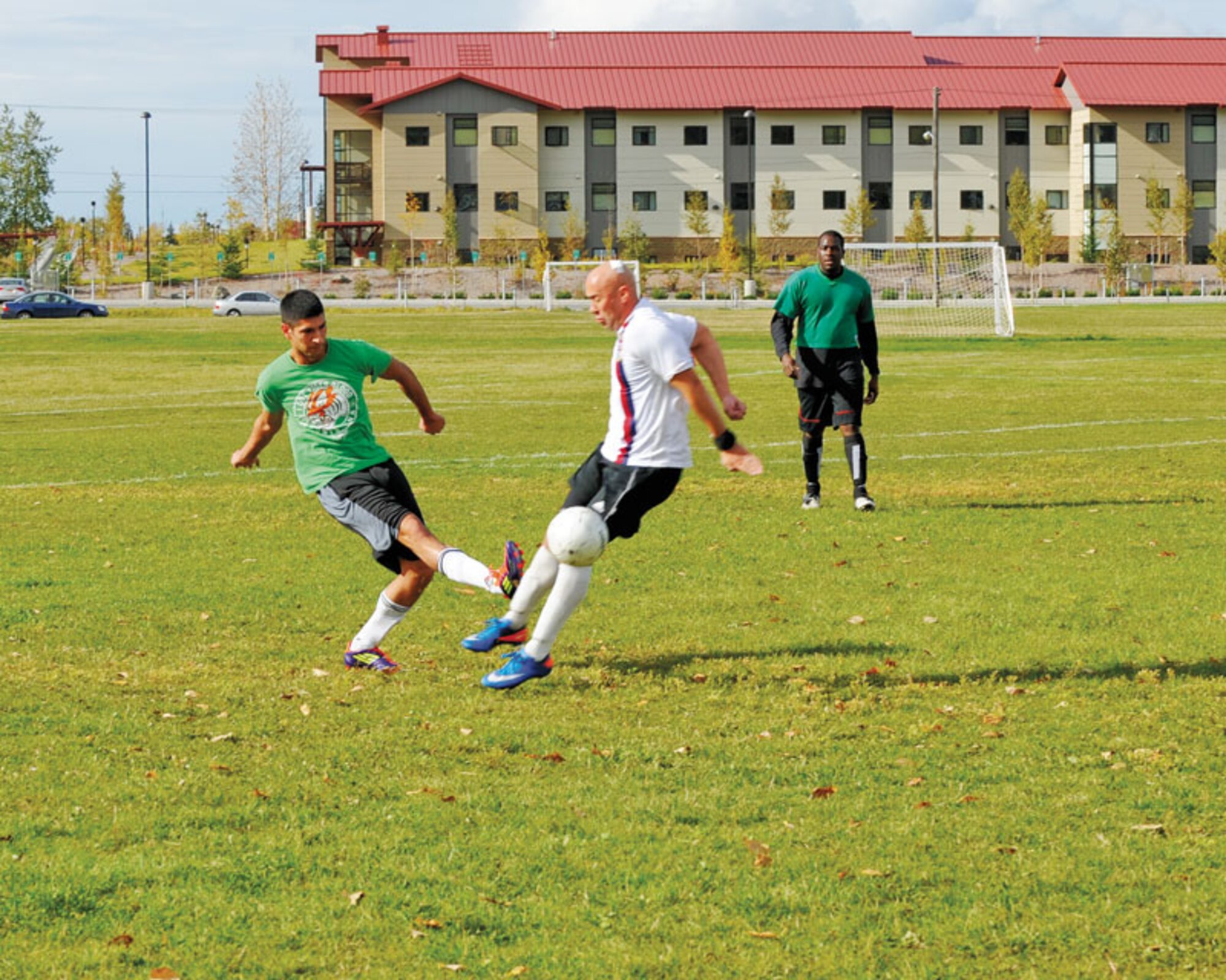 Marc Thompson of the 673d Medical Group takes the ball from a 725th BSB Soldier.
 (U.S. Air Force photo/Steven White)