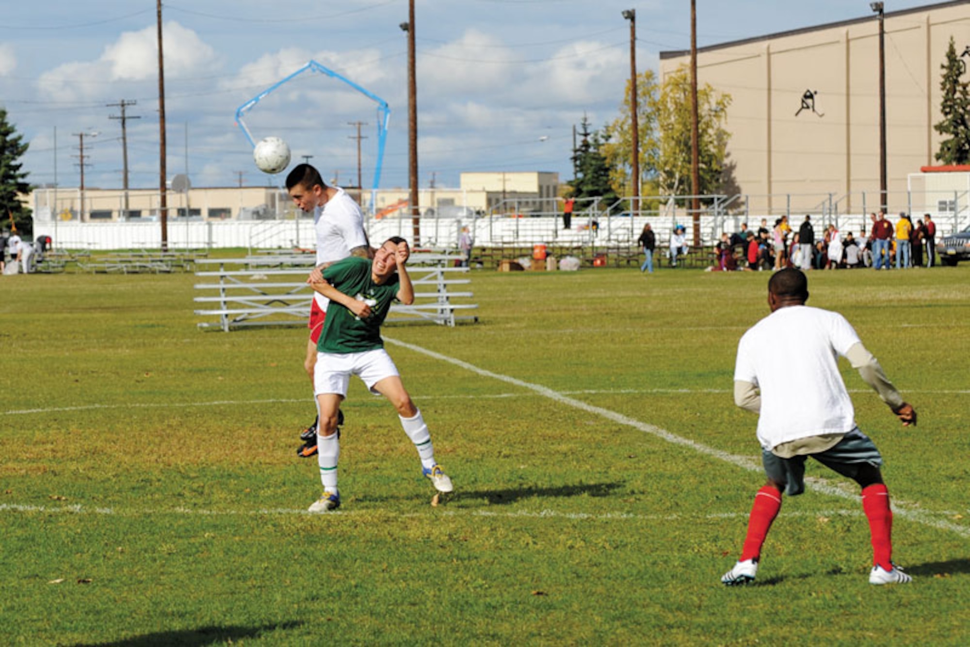 Marc Thompson of the 673d Medical Group ducks as Sean Brown of Co. F, 725th BSB, heads the ball.  (U.S. Air Force photo/Steven White)