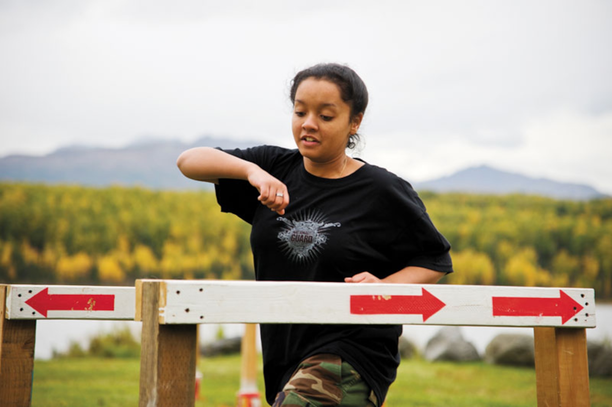 Danashia Porcher, a freshman at Dimond High School, makes her way through the Run, Dodge and Jump event, an old Army Physical Fitness Test event which requires the runner to weave between wooden dividers and leap over a wide “ditch,” marked with tape, at top speed.  (U.S. Air Force photo/Johnathon Green)