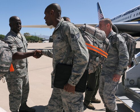 DAVIS-MONTHAN AIR FORCE BASE, Ariz. – Chief Master Sgt. Vincent Howard welcomes home an Airman from the 355th Maintenance Group on the flight line here Sept. 18. Members of the 355th Maintenance Group return from a 6-month deployment at Osan Air Base, Republic of Korea. (U.S. Air Force photo/Airman 1st Class Christine Halan)