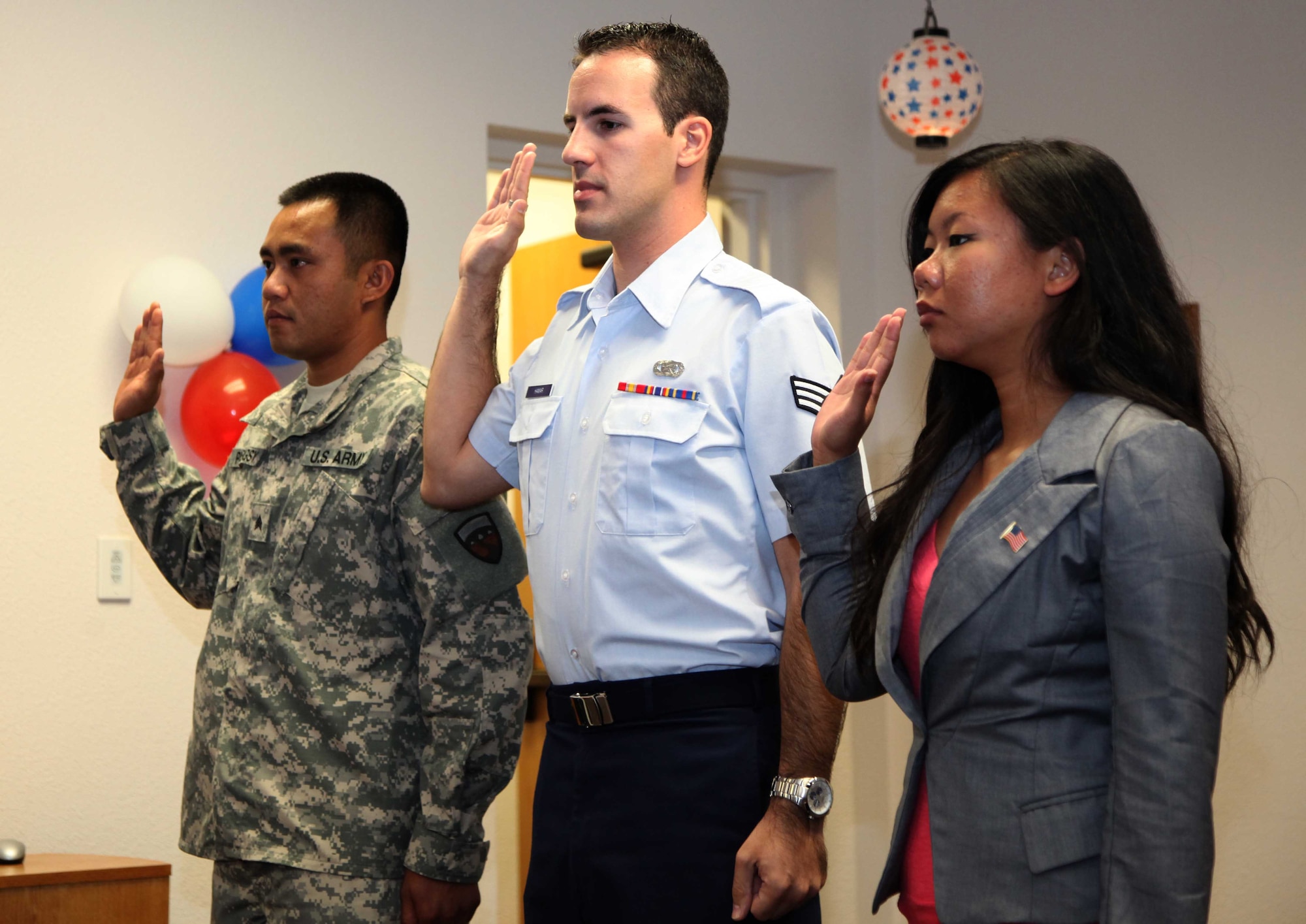 Senior Airman Adam Hamar (center) takes the Oath of Allegiance during a military naturalization ceremony, Sept. 16, 2011, at the Airman and Family Readiness Center on Travis Air Force Base, Calif.  Hamar, a Hungarian-born immigrant, has served as a Reservist with the 940th Wing at Beale Air Force Base, Calif., since 2009. He joins the more than 64,000 military members who have been naturalized since September 2001, according to U.S. Citizenship and Immigration Services.. (U.S. Air Force photo/Tech.Sgt. Kenneth McCann)