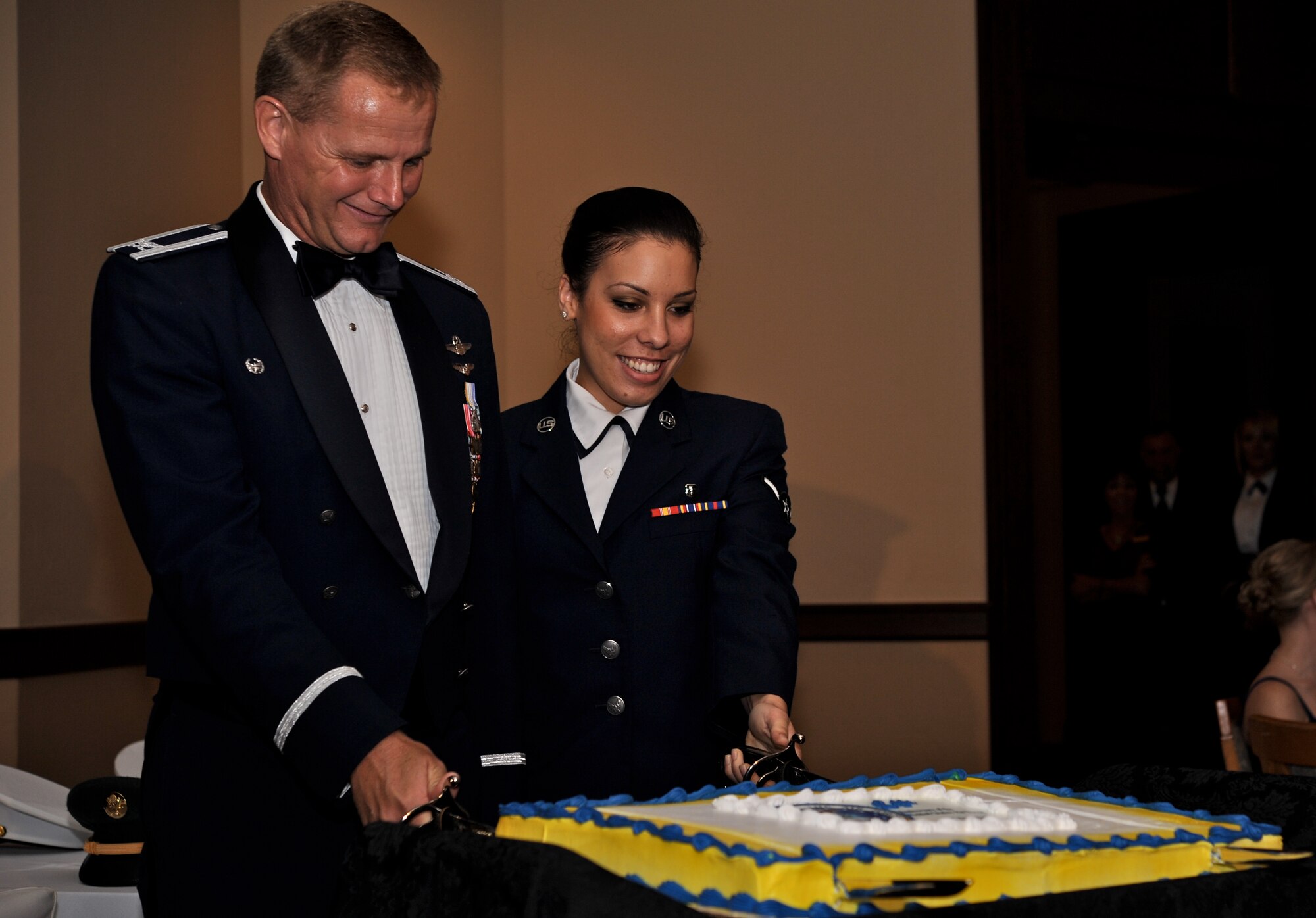 VANCE AIR FORCE BASE, Okla. – Col. Russ Mack, the 71st Flying Training Wing commander, and Airman Kyrsys Sierra-Arenas, 71st Medical Operations Squadron, cut the cake during the Vance Air Force Base Birthday Ball. Following tradition, both swords stayed in the cake once it was cut. (U.S. Air Force photo/ Staff Sgt. James Bolinger)