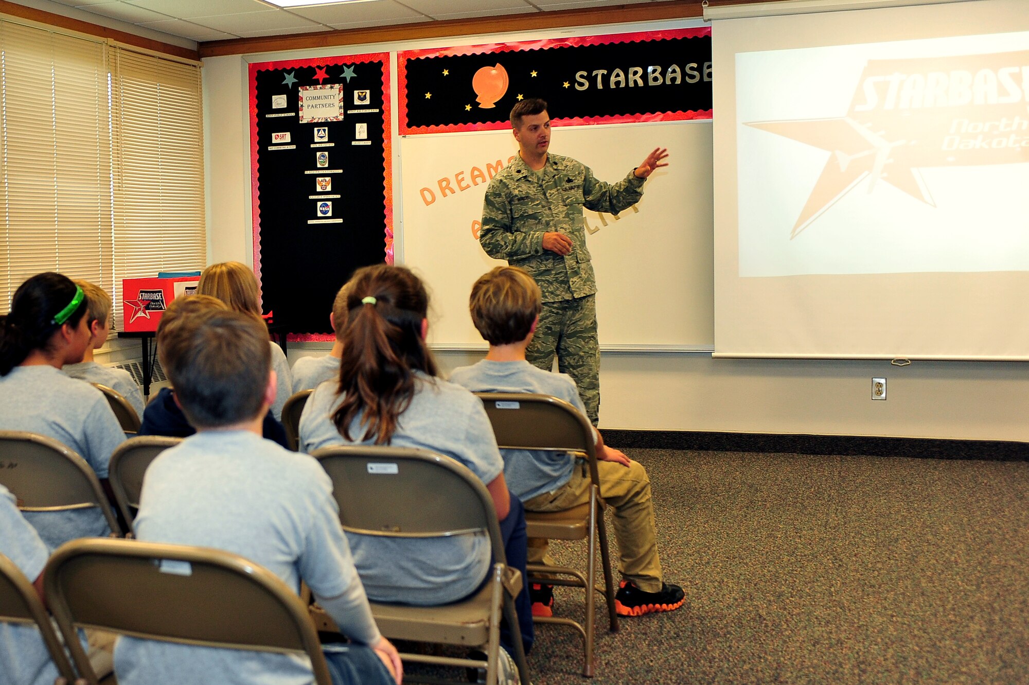 MINOT AIR FORCE BASE, N.D. – Lt. Col. Sean Wade, 5th Logistics Readiness Squadron commander, speaks to the first class to graduate under the STARBASE North Dakota program, a premiere Department of Defense education program at the North Plains Elementary School here, Sept. 20. The curriculum of the DoD STARBASE Program is designed for fifth-grade students and is based on national standards. STARBASE is sponsored by the Office of the Assistant Secretary of Defense, providing students with 20-25 hours of stimulating experiences with bases of all services across the. (U.S. Air Force Photo / Senior Airman Jesse Lopez)
