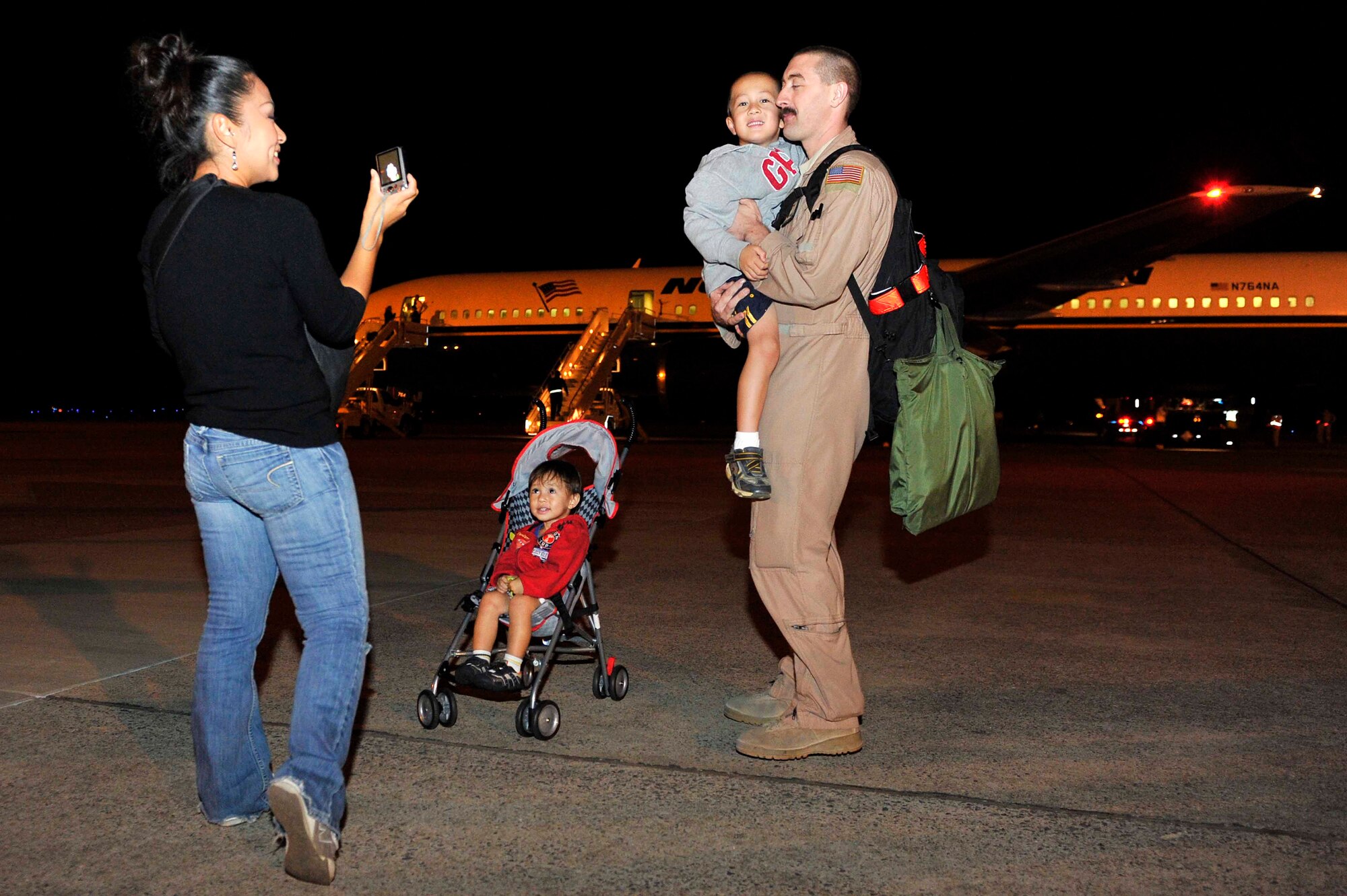Staff Sgt. Nick Hooker is welcomed home by his wife, Hiromi, and their sons, Monty and Mason, Sept. 20, at Little Rock Air Force Base, Ark. Families and friends greeted nearly 120 Airmen returning from deployments supporting operations in Southwest Asia. (U.S. Air Force photo by Staff Sgt. Chris Willis)