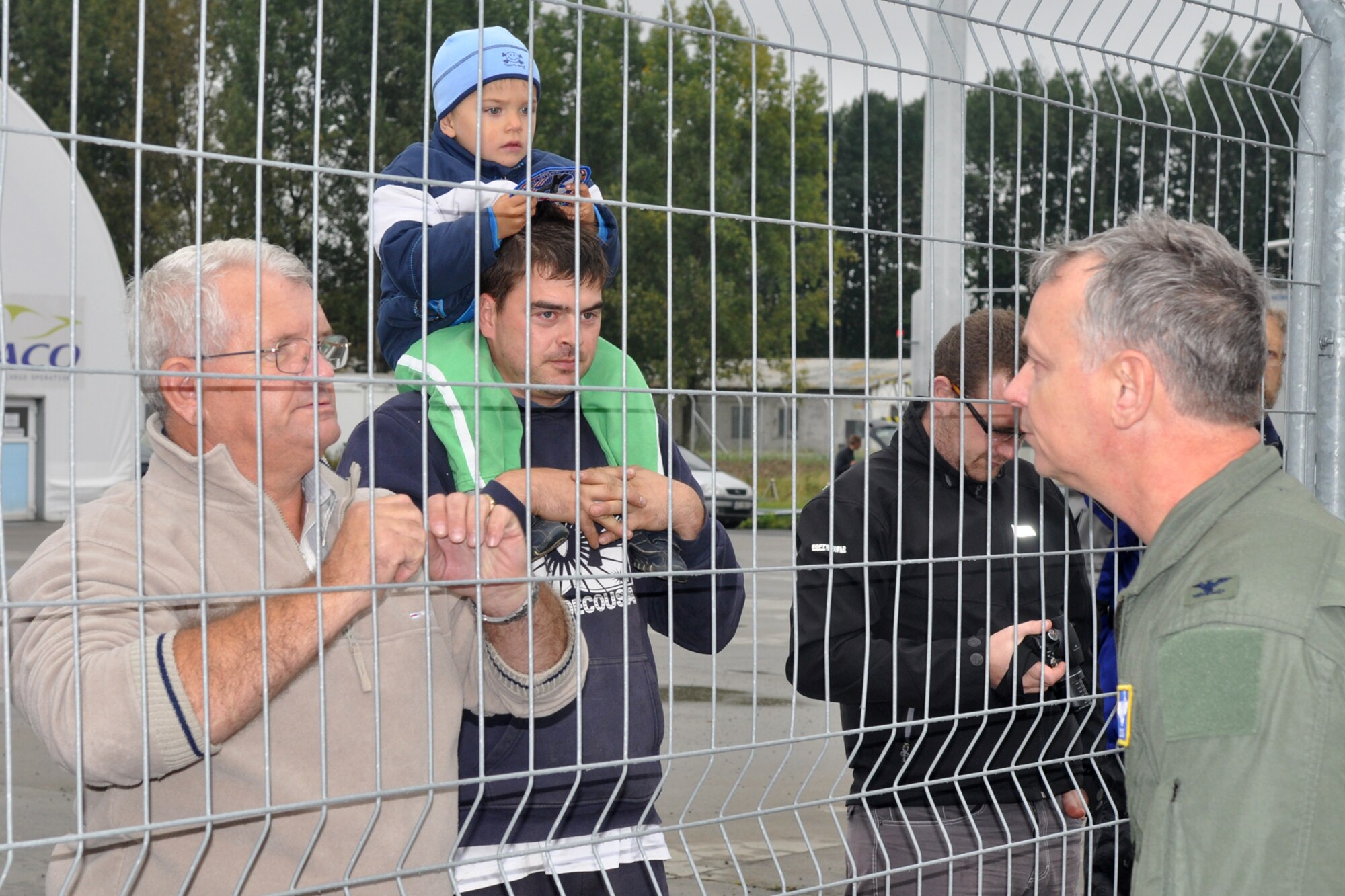 Col. Joseph Jones, the 307th Bomb Wing vice commander, gives a commemorative patch to a child as he talks to a few local residents who came out to watch the arrival of a B-52 Stratofortress at the Ostrava Airport in the Czech Republic, Sept. 20, 2011. Jones was part of the crew of the B-52 from the 93rd Bomb Squadron, 307th BW, and arrived in the Czech Republic to participate in the North Atlantic Treaty Organization Days in Ostrava air show, which is scheduled for Sept. 24-25, 2011, at the Leos Janacek Ostrava Airport, Ostrava, Czech Republic. (U.S. Air Force photo by Tech. Sgt. Jeff Walston/Released)