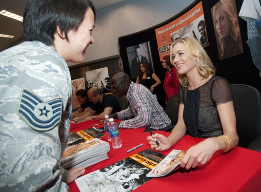 Tech. Sgt. Yvonne Santos, 95th Force Support Squadron, receives an autograph from model and actress Yvonne Strahovski.  Strahovski is a regular on the NBC sit-com “Chuck” and plays Anne in “Killer Elite.” (Air Force photo by Rob Densmore)