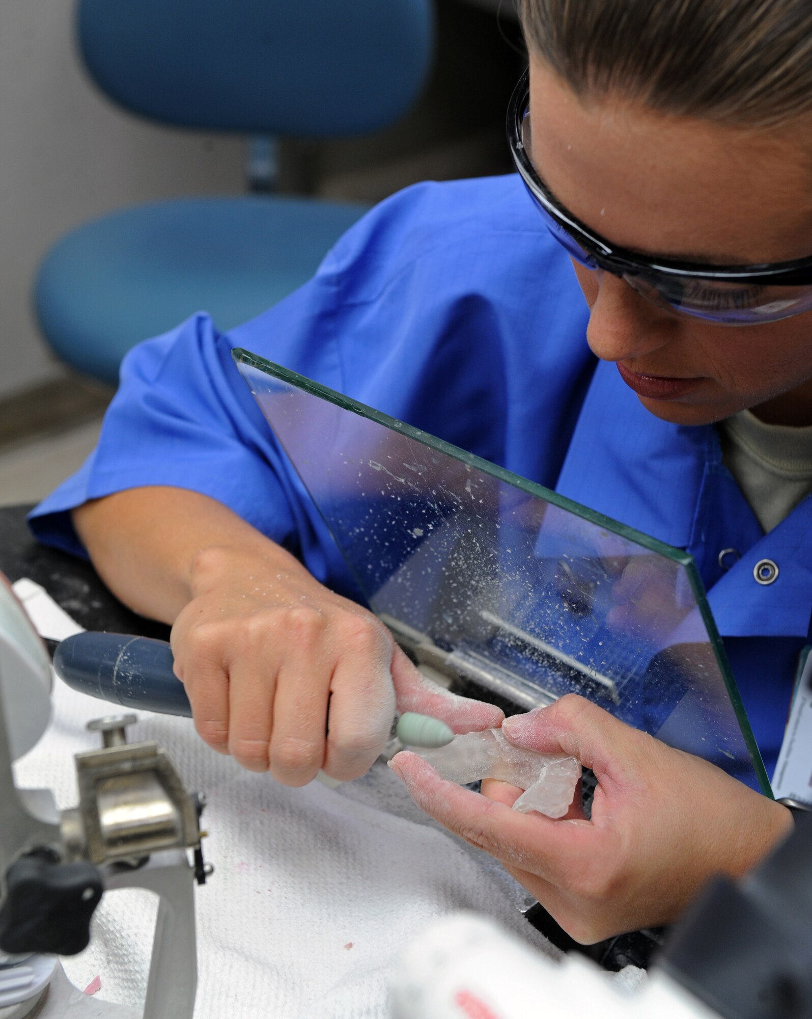 Tech. Sgt. Jennifer Barlow, 2nd Dental Squadron, uses a hand tool to flatten the surface of a night guard in the dental lab on Barksdale Air Force Base, La., Sept. 21. Night guards are used to protect teeth from grinding against each other while the wearer sleeps. (U.S. Air Force photo/Airman 1st Class Micaiah Anthony)(RELEASED) 
