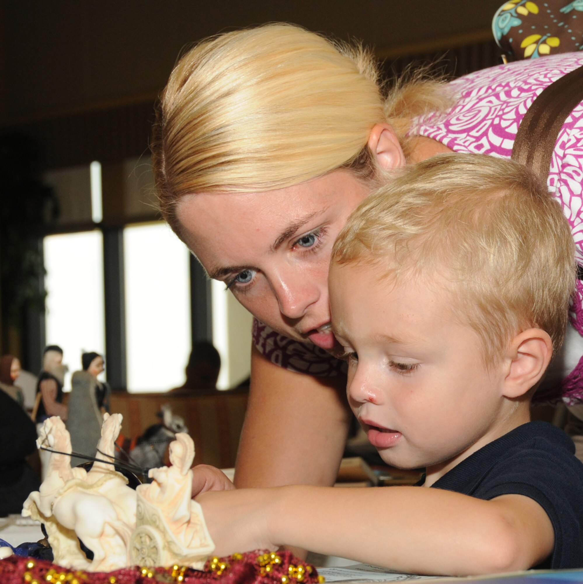 Laura Robins, who's married to Capt. Radley Robins, 81st Dental Squadron, and their 3-year-old son, Jack, look at Greek artifacts on display at Diversity Day, Sept. 13 at the Bay Breeze Event Center.  The cultural celebration also included music, literature, dancing, poetry, face painting, games and food for children and adults.  (U.S. Air Force photo by Kemberly Groue)