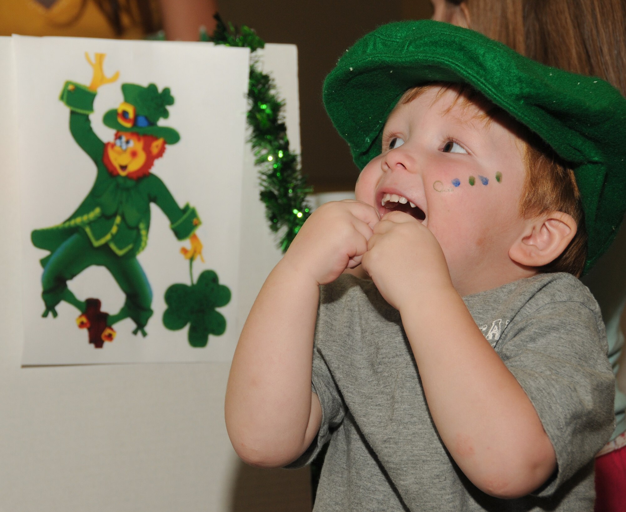 Peyton Kennedy, 2, wears a green cap to proclaim his heritage in front of the Ireland
booth. His parents are Amber and Capt. Stephen Kennedy, 81st Medical Operations Squadron.  (U.S. Air Force photo by Kemberly Groue)