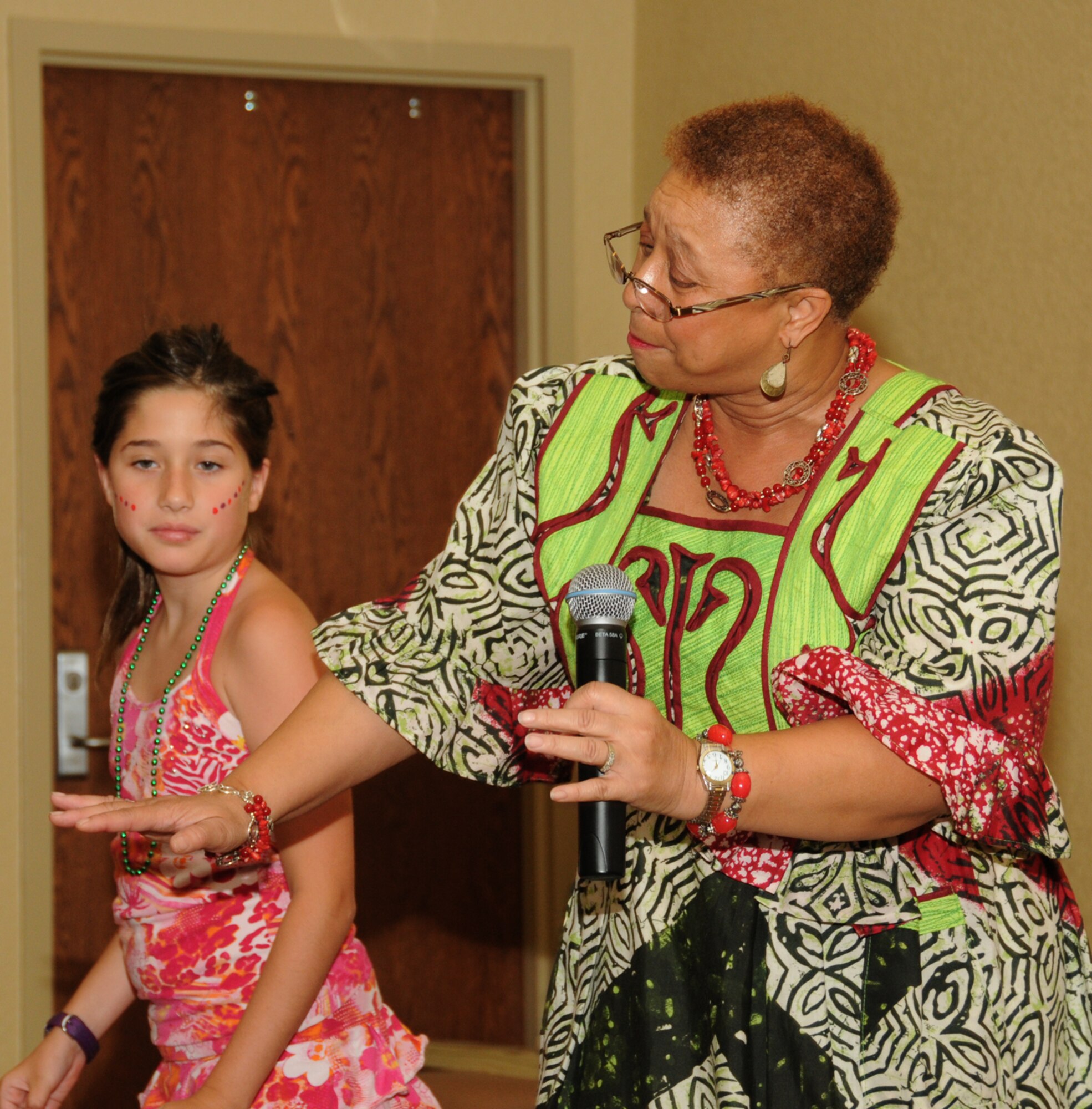 Alexis Hurtle, 9, learns a traditional dance from Zimbabwe from Beverly Mhlanga of Gulfport, who sings “Tichanoimba Hosanah.”  Alexis is the daughter of Alisa and Lt. Col. William Hurtle, 81st Aerospace Medicine Squadron.  (U.S. Air Force photo by Kemberly Groue)