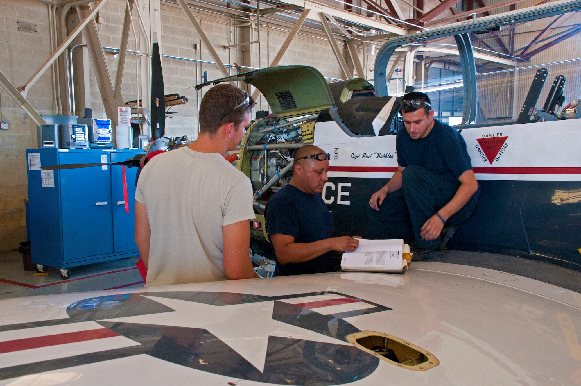 LAUGHLIN AIR FORCE BASE, Texas - Members of the 47th Maintenance Directorate
go over paper work before conducting maintenance on a T-6A Texan II aircraft
here Sept. 21. Fifty people from the directorate came together Sept. 16
through 18 to inspect Laughlin's entire T-6 fleet after a command order by
the Air Education and Training Command was given for them to be grounded.
(U.S. Air Force photo/Senior Airman Scott Saldukas)
