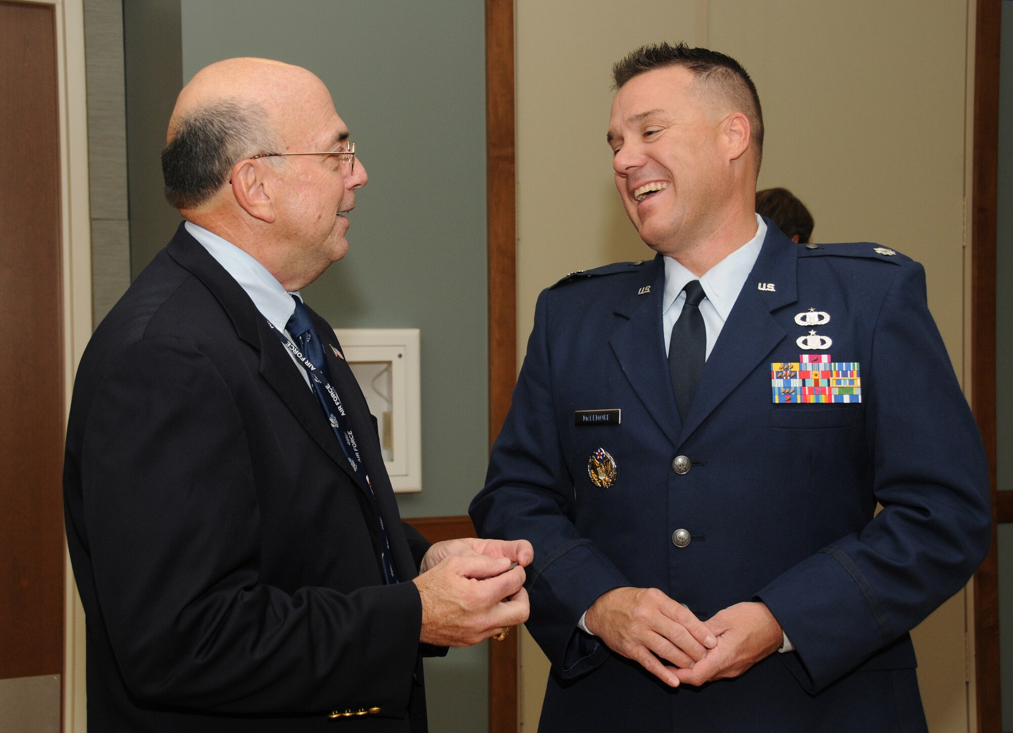 Richard Heath, director of the Air Force Retirement Home in Gulfport, enjoys a laugh with Lt. Col. Jeffrey McLemore, 334th Training Squadron commander, at the home's Air Force birthday party Sept. 16.  McLemore was the guest speaker for the occasion.   (U.S. Air Force photo by Kemberly Groue)