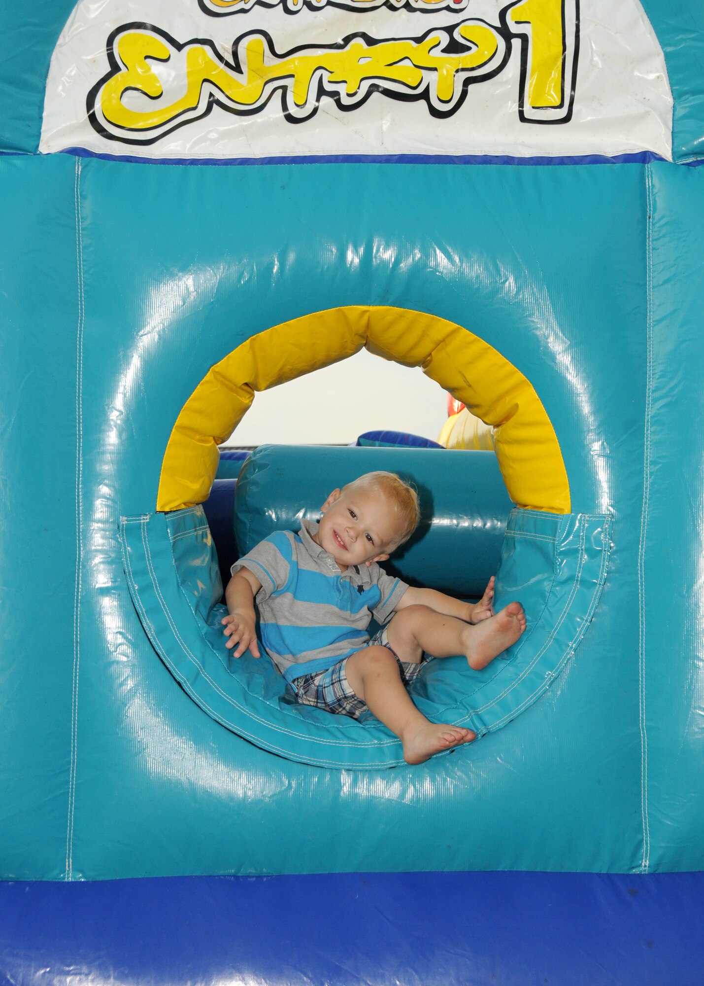 Ramsey Bush, 2, son of Jessica and Capt. Chris Bush, 335th Training Squadron, pauses in the inflatable obstacle course at the Air Force birthday celebration Sept. 16 on the parade grounds.  (U.S. Air Force photo by Kemberly Groue)