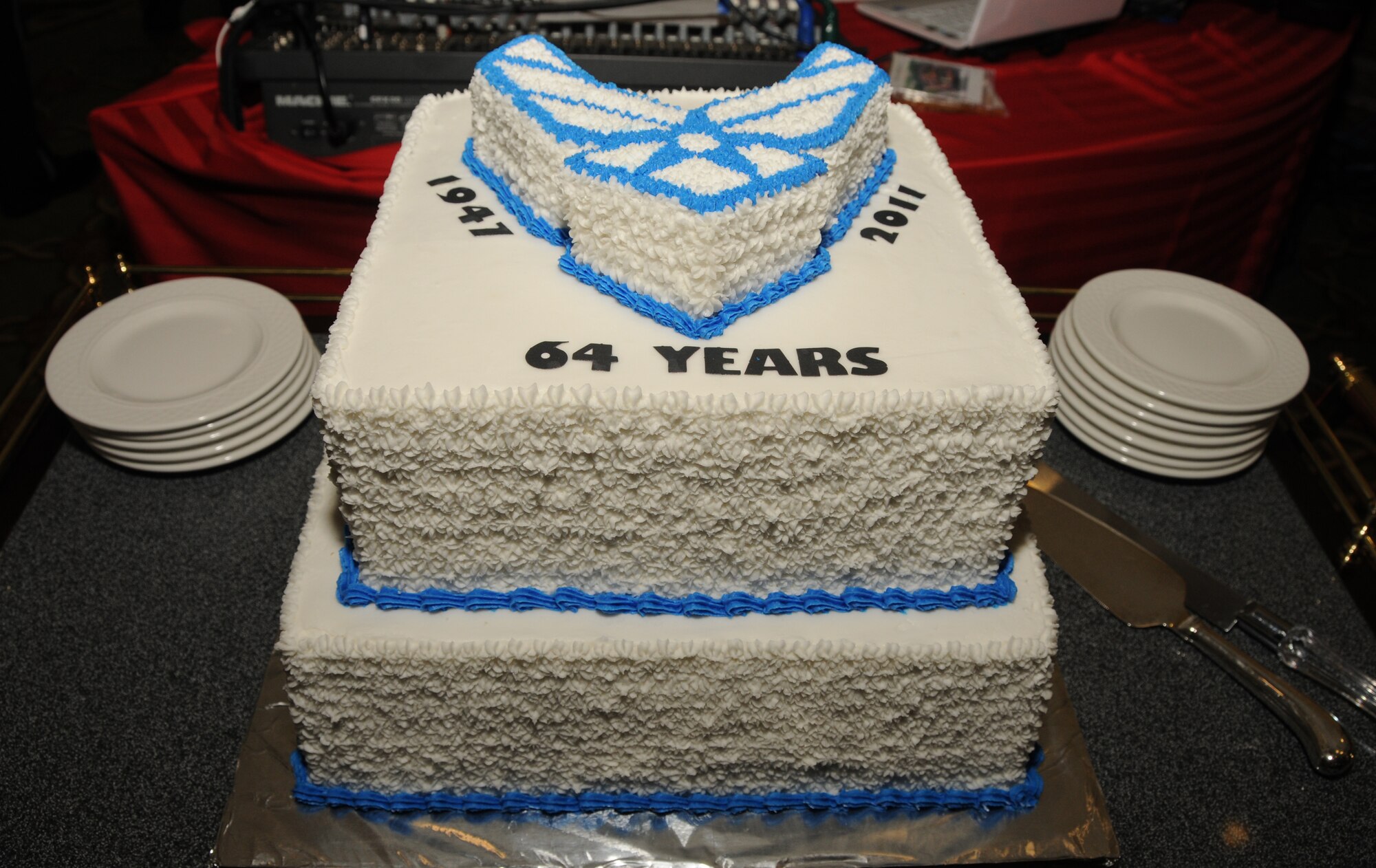 Retired Chief Master Sgt. Chris Moore, the oldest guest at the Air Force Ball, passed a slice of cake to the youngest guest, Airman David Lepin, to symbolize the Air Force’s enduring heritage. Lepin, 19, is an aerospace medical apprentice student in the 81st Medical Group.  (U.S. Air Force photo by Kemberly Groue)
