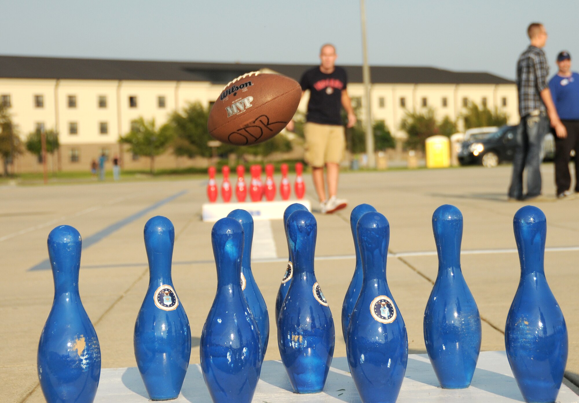 Second Lt. Alan Geason, 333rd Training Squadron, plays a game of football bowling on the parade field at the Air Force 64th birthday party Sept. 16. The event featured live music, food, beverages, games, contests and prizes. Lt. Col. Jeffrey McLemore, 334th TRS commander, spoke at Friday’s Armed Forces Retirement Home observance in Gulfport. The Keesler Honor Guard and student volunteers from the 366th TRS Detachment 6 at the Naval Construction Battalion Center in Gulfport also participated. Saturday’s Air Force Ball, sponsored by the Air Force Association John C. Stennis Chapter 132 at the Bay Breeze Event Center, featured a prisoner of war as guest speaker, Biloxi High School jazz band, cake cutting, dancing and prizes.  (U.S. Air Force photo by Kemberly Groue)