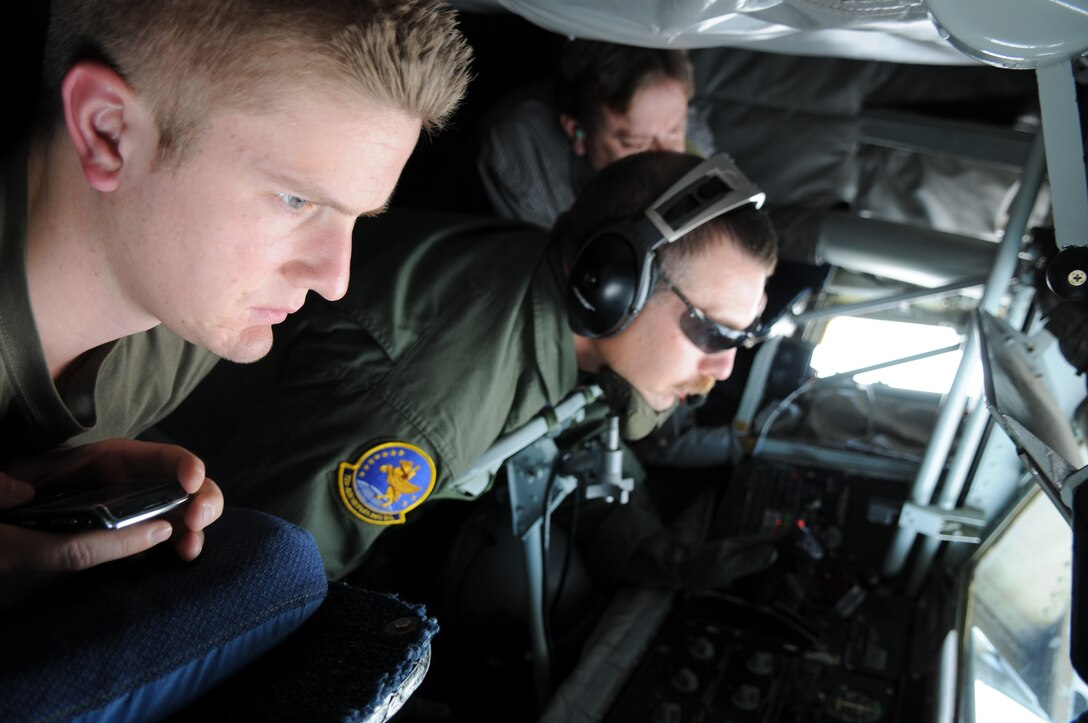 GRISSOM AIR RESERVE BASE, Ind. -- Nick Bock, case manager for Congressman Joe Donnelly, and Duane Arndt, special assistant for Congressman Joe Donnelly, watch as Master Sgt. Paul Sherrod, 72nd Air Refueling Squadron in-flight refueling technician, guides the boom into the receiving end of a B-52 Stratofortress during a refueling mission Sept. 14. Arndt and Bock were two of the nine staffers on board that got the opportunity to see a refueling mission. The purpose of their visit was to give the staffers the opportunity to learn about the impact Grissom has not only in helping preserve America's freedom but the economic value that it has on the surrounding community. (U.S. Air Force photo/Senior Airman Jami K. Lancette) 