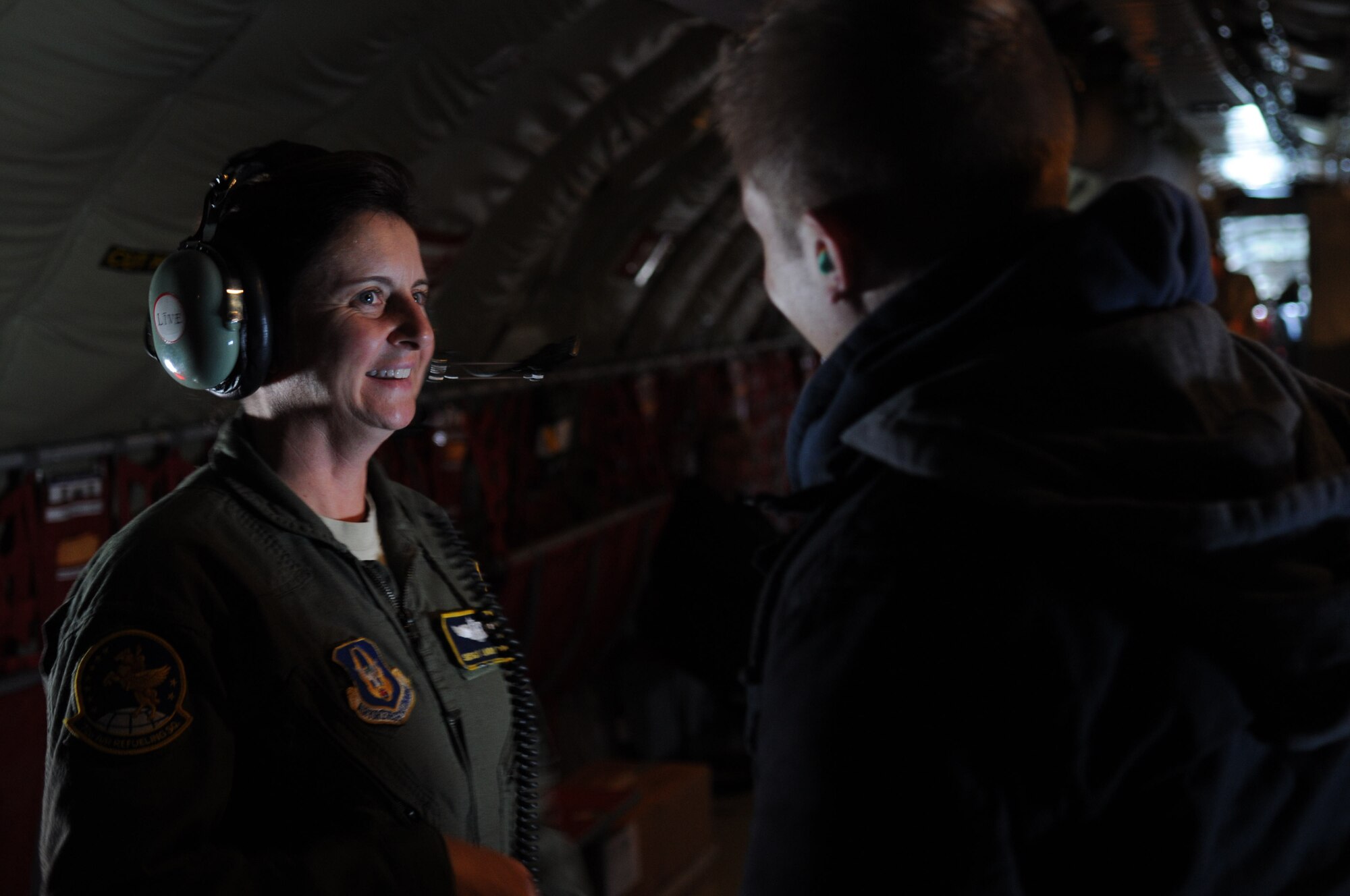 GRISSOM AIR RESERVE BASE, Ind. -- Senior Master Sgt. Laura McKee, 72 Air Refueling Squadron in-flight refueling technician, talks with Nick Bock, case manager for Congressman Joe Donnelly, during an in-flight refueling mission Sept. 14. Bock was one of nine congressional staffers on board during the mission. The purpose of their visit was to give the staffers the opportunity to learn about the impact Grissom has not only in helping preserve America's freedom but the economic value that it has on the surrounding community. (U.S. Air Force photo/Senior Airman Jami K. Lancette) 
