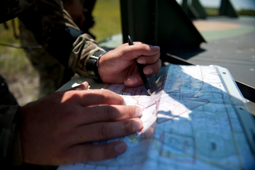 U.S. Air Force Senior Airmen Jess Hager, 11th Air Support Operations Squadron joint terminal attack controller, uses a map to determine and mark enemy positions during Exercise Atlantic Strike 11-02 at Avon Park Air Force Range, Fla., Sept. 14, 2011. Hager used a combination of maps, target "talk-on" and natural instinct to provide aircrews with accurate coordinates to enemy locations and help place bombs on target. (U.S. Air Force photo by Staff Sgt. Jamal D. Sutter/Released)
