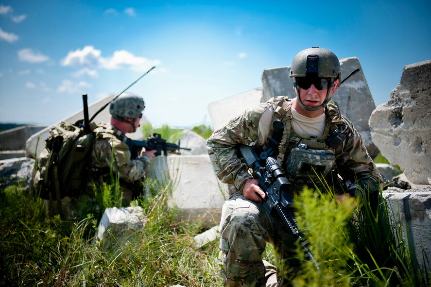 U.S. Air Force Senior Airmen Jess Hager, right, and James Ingram, 11th Air Support Operations Squadron joint terminal attack controllers, take cover during Exercise Atlantic Strike 11-02 at Avon Park Air Force Range, Fla., Sept. 14, 2011. Hager and Ingram are stationed at Fort Hood, Texas, and typically work with U.S. Army joint fires observers. (U.S. Air Force photo by Staff Sgt. Jamal D. Sutter/Released)