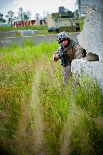 A U.S. Marine Corps 2nd Tank Battalion antitank missileman out of Marine Corps Base Camp Lejeune, N.C., positions himself around a makeshift structure during Exercise Atlantic Strike 11-02 at Avon Park Air Force Range, Fla., Sept. 13, 2011. During the scenario, the antitank missilemen’s job was to eliminate the opposing forces while providing support to U.S. Air Force joint terminal attack controllers. (U.S. Air Force photo by Staff Sgt. Jamal D. Sutter/Released)
