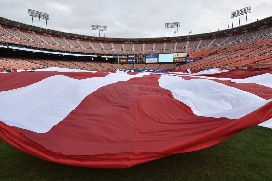 California Air National Guardsmen from the 129th Rescue Wing, Moffett Federal Airfield, Calif., and Airmen from Travis Air Force Base, Calif., participate in a flag ceremony in rememberance of the Sept. 11th terrorist attacks, Candlestick Park, San Francisco, Calif., Sept. 11, 2011.  Approximately 200 Airmen from the 129th Rescue Wing and from Travis Air Force Base, Calif., took part in the ceremony.  (Air National Guard Photo by Airman 1st Class John Pharr)