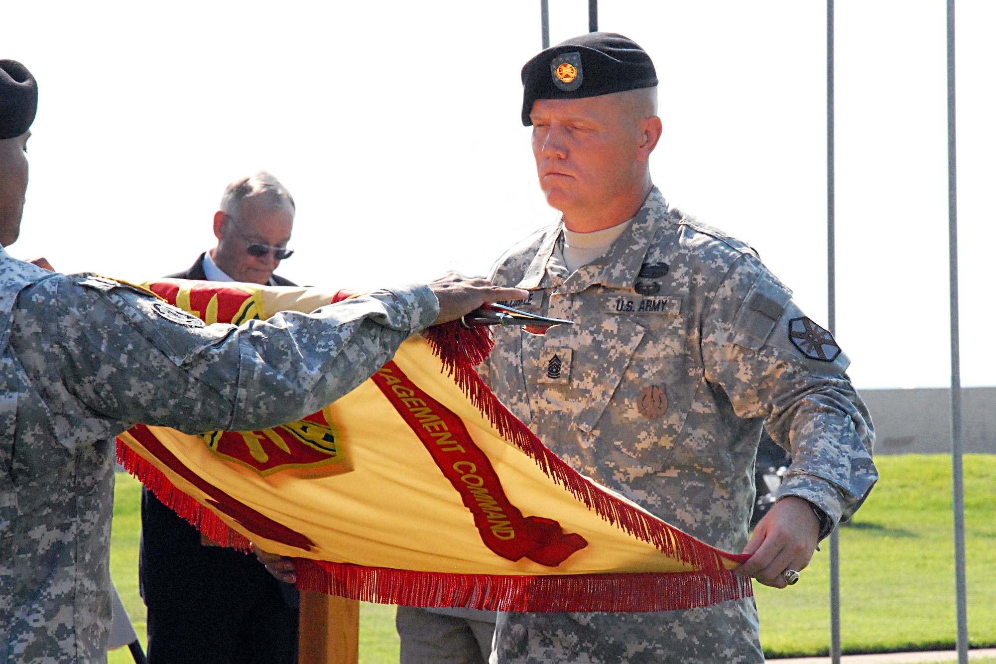 (From left) Fort Monroe Garrison Commander Col. Anthony D. Reyes and Command Sgt. Maj. Lesly McCorkle furl the garrison colors for final casing at Fort Monroe's deactivation ceremony Sept. 15. The historic fort, known as "Freedom's Fortress," deactivated after 188 years of service. (U.S. Army photo by Sid Lilly/Released)
