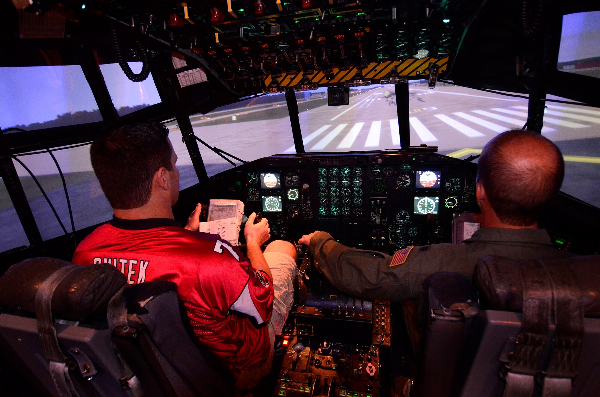 Will Svitek, a tackle with the Atlanta Falcons football team flies the C-130 flight simulator, coming in over the runway threshold at Dobbins Air Reserve Base, Sept. 20. The football team members came to Dobbins to show their appreciation for what the military does every day.   (U.S. Air Force photo/ Brad Fallin)