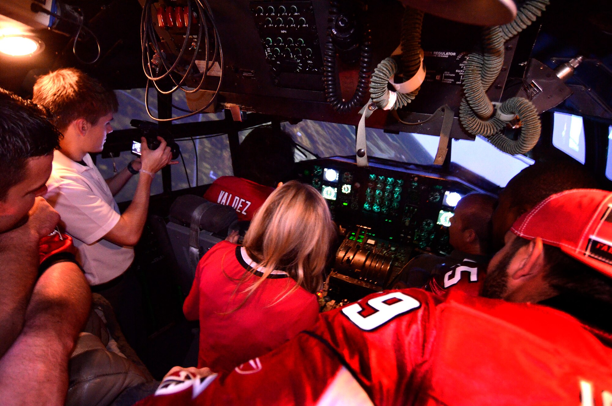 Atlanta Falcons football team members go for a ride in the C-130 flight simulator with guard, Jose Valdez at the controls, at Dobbins Air Reserve Base, Sept. 20. The football team members visited Dobbins to show their appreciation for what the military does every day.   (U.S. Air Force photo/ Brad Fallin)
