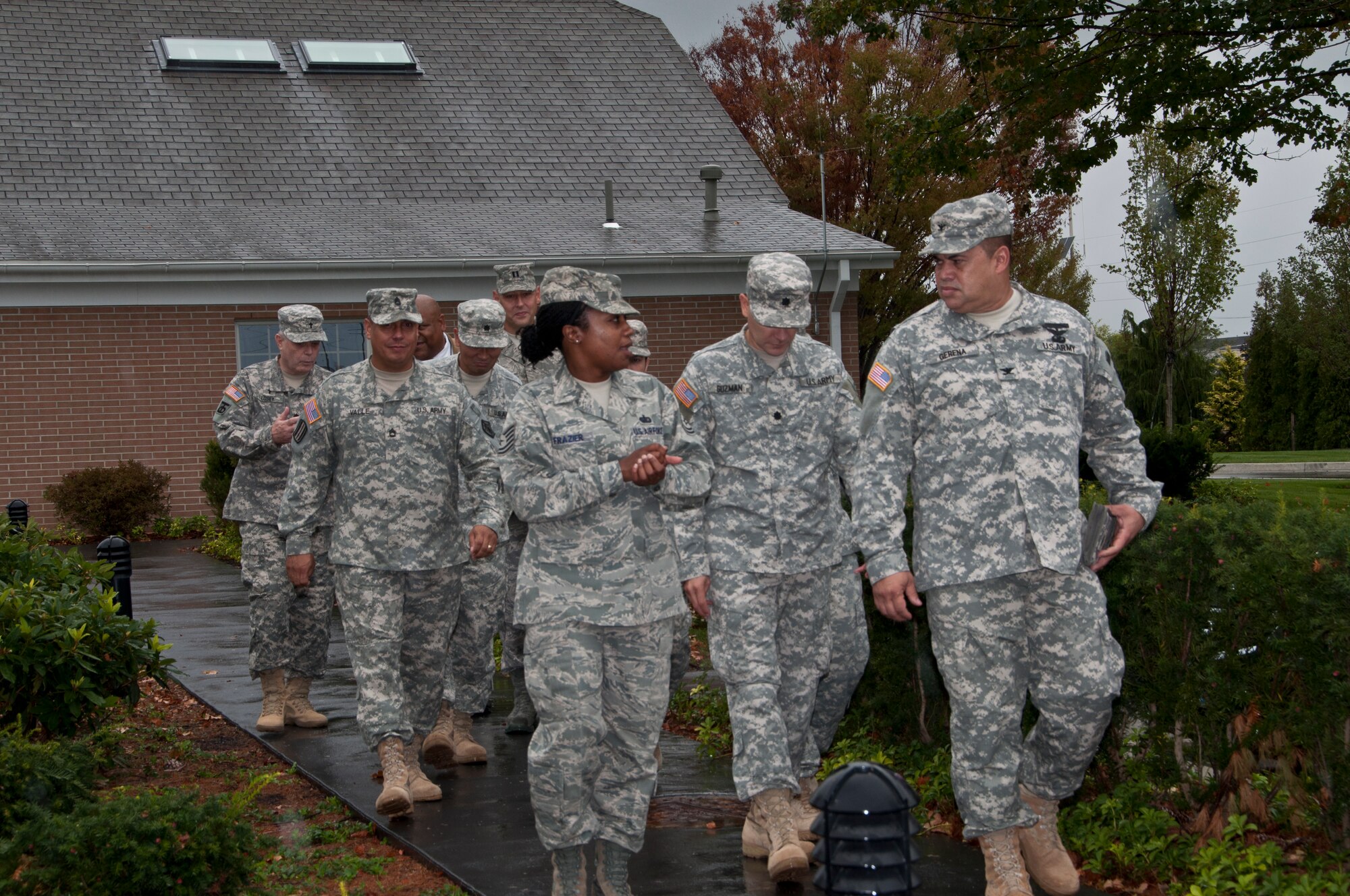 Army Col. Alfredo Gerena, deputy commander, 1st Mission Support Command, Puerto Rico, and Lt. Col. Juan Guzman tour the Campus for Families of the Fallen at Dover Air Force Base, Del. with Tech. Sgt. Latersa Frazier, NCO in charge, Familes of the Fallen Support Branch, Air Force Mortuary Affairs Operations Sept. 20, 2011. (U.S. Air Force Photo/Staff Sgt. Agustin Salazar)