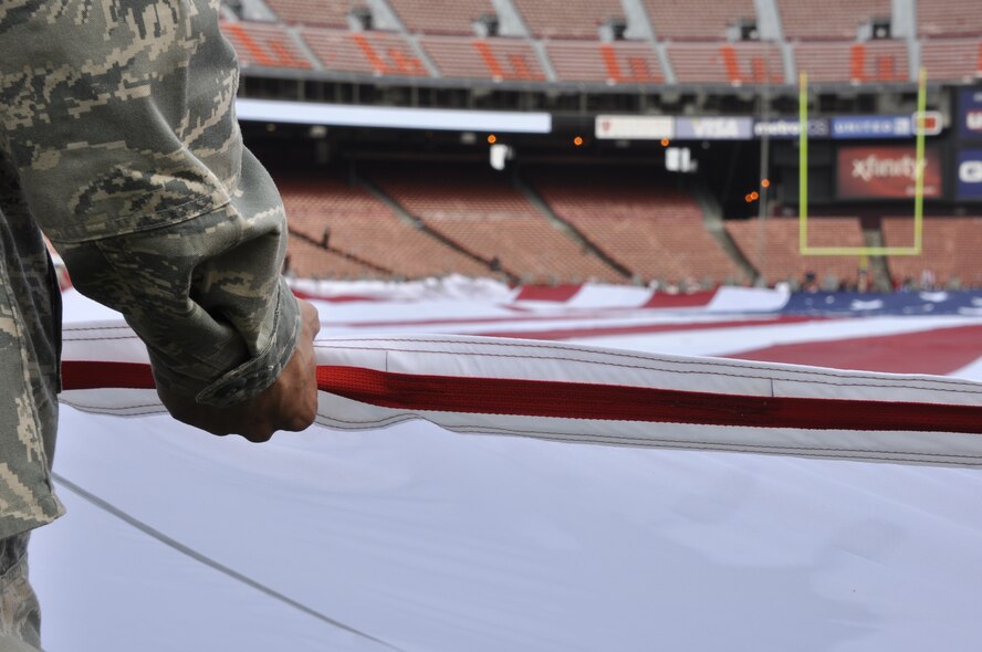 California Air National Guardsman Technical Sgt. Douglas Brock from the 129th Rescue Wing, Moffett Federal Airfield, Calif., participates in a flag ceremony in rememberance of the Sept. 11th terrorist attacks, Candlestick Park, San Francisco, Calif., Sept. 11, 2011.  Approximately 200 Airmen from the 129th Rescue Wing and from Travis Air Force Base, Calif., took part in the ceremony.  (Air National Guard Photo by Airman 1st Class John Pharr)