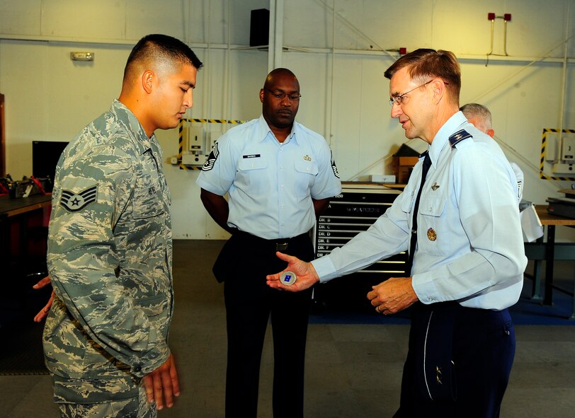 U.S. Air Force Staff Sgt. Victor Reyes, 20th Maintenance Group, receives a coin from Maj. Gen. Stephen Hoog, 9th Air Force commander, Shaw Air Force Base, S.C. Sept. 19, 2011. Hoog took a tour around Shaw to see and thank team members of the base for their hard work and dedication.  (U.S. Air Force photo/Airman 1st Class Neil D. Warner) (Released)