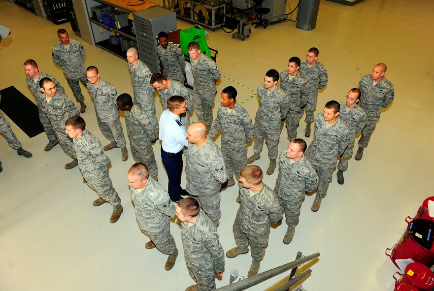 U.S. Air Force Maj. Gen. Stephen Hoog, 9th Air Force commander, commemorates the 20th Maintenance Group for an outstanding job while standing in formation inside a hanger on Shaw Air Force Base, S.C. Sept. 19, 2011. Hoog took a tour around Shaw to see and thank team members of the base for their hard work and dedication.  (U.S. Air Force photo/Airman 1st Class Neil D. Warner) (Released) 